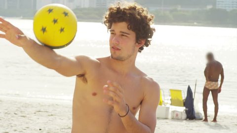 Young Attractive man poses with a soccer ball.
