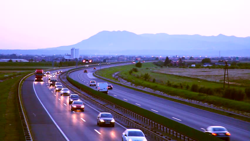 Car driving on the Highway in the sunset