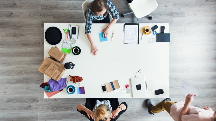 Mixed race group of people aerial view timelapse hipster office small business start up company planning creative meeting