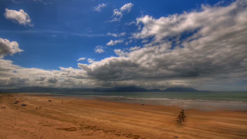 Clouds passing over Irish beach and mountains, HD time lapse clip, high dynamic