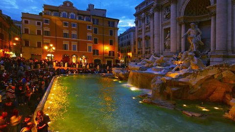 ROME, ITALY - MAY 20, 2014: Multiple tourists by fountain Trevi at night. Trevi is one of most famous fountains of the world. Time-lapse.