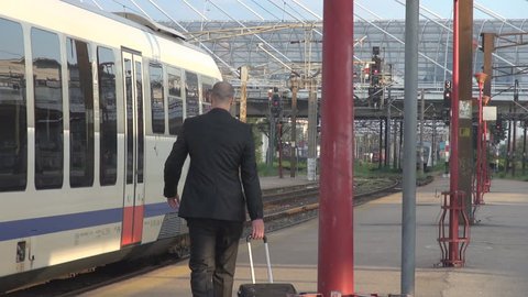 Business man commuter running, missed train in railway station