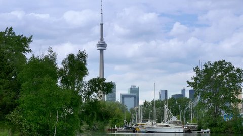 TORONTO, ONTARIO, CANADA - Circa June, 2014 - Passing by a marina on Toronto Island with the CN Tower in the background.