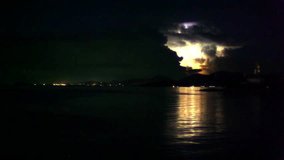 Lightning in the sea during the night time. Flies Ufo. Time lapse video speed up