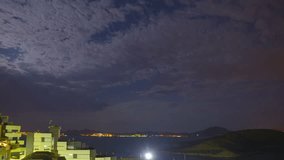 Night landscape with moon, sea and clouds. Mar menor, Spain. Time-lapse.