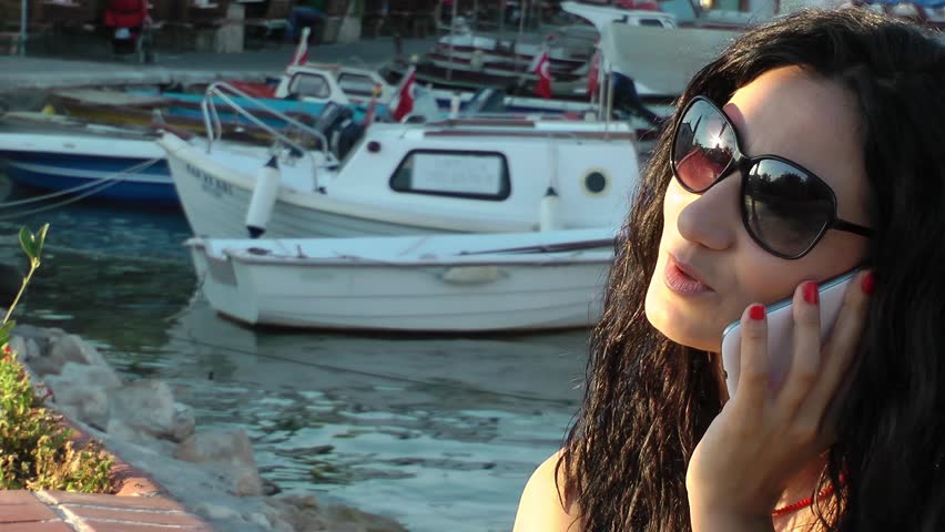 Girl Talking with Cellphone in a Dock