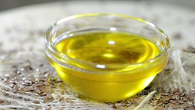 Flaxseed Oil in a small bowl (rotating seamless loopable full HD video)