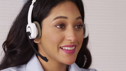 Mexican telemarketer talking with headset