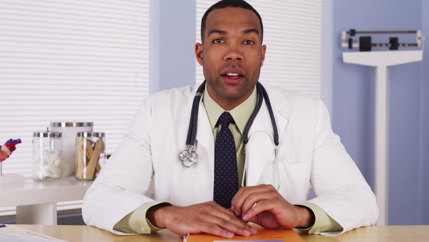 Black doctor talking to camera Royalty-Free Stock Footage #6617315