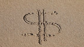 Sign 'Dollar' drawn in the sand, water rushes over and washes it away
