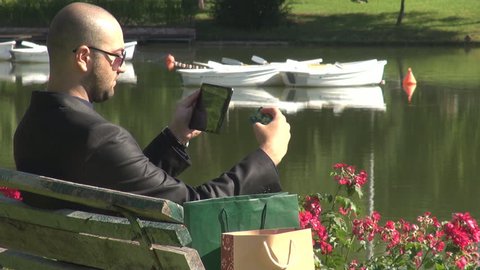 Business man with shopping bags doing online shopping with credit card, tablet