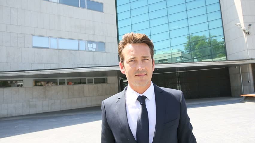 Businessman walking in front of modern building