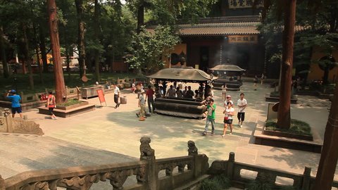 HANGZHOU, ZHEJIANG PROVINCE, PEOPLE'S REPUBLIC OF CHINA - JUNE 14, 2014: visitors in courtyard at Lingyin Temple. Temple of Soul's Retreat, chan sext Buddhist temple.