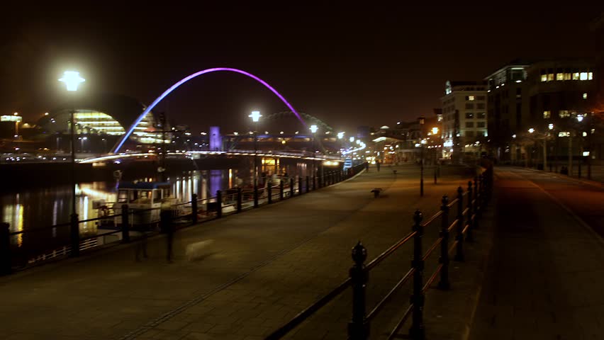 Modern architecture and bridge in the city, time lapse at night.