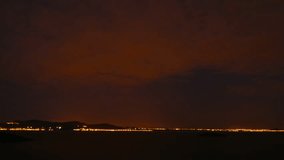Night landscape with moon, sea and clouds. Mar menor, Spain. Time-lapse.