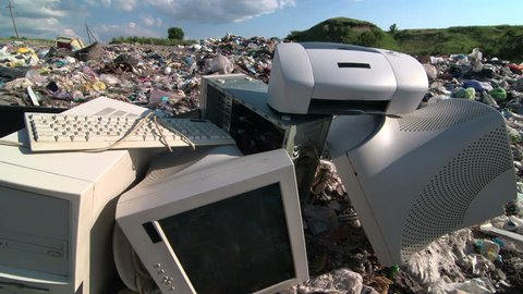 Old desktop computer parts at the garbage dump tracking shot