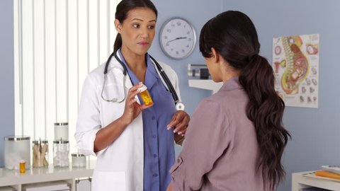 African American OBGYN talking about prescription to patient