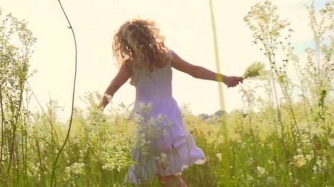 Happy young woman having fun outdoor. Beauty girl running and laughing. Excited with the freedom of the countryside. Nature. Freedom concept. Slow motion 1920x1080p. Sun flare. High speed camera shot