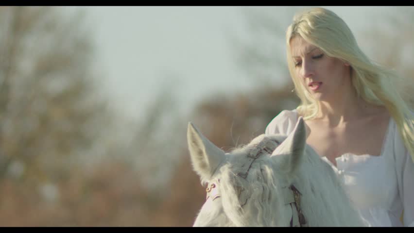 Young angel woman horseback riding in nature  