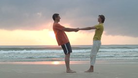 HD 1080i: Mature couple dancing hand in hand on a beach on sunrise or sunset - Powered by Shutterstock - Get 15% off with code: PIKWIZARD15