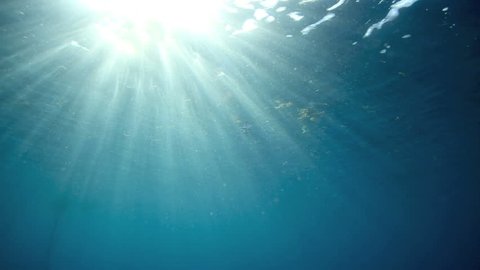 Blue ocean underwater surface with rays of light