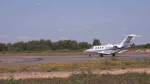 Cessna Citation business jet taxis for take off and begins take off roll at Blackbushe Airport, Hampshire, UK, June 2014