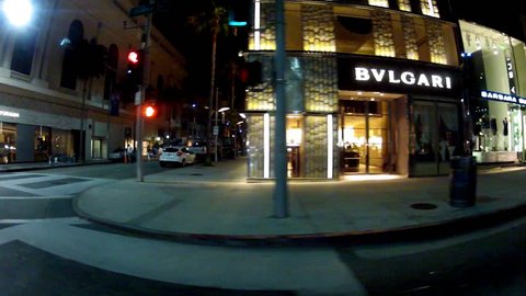 BEVERLY HILLS, CA: March 11, 2014- Shot of night driving by expensive designer stores on Rodeo Drive circa Beverly Hills. Night view of pricey, exclusive name brand stores of popular designers.