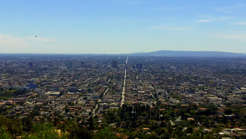 High and wide shot of a Southward view of a Los Angeles and Hollywood district from Griffith Park. This clip features a view down to the city below showing the expansiveness of the LA area.