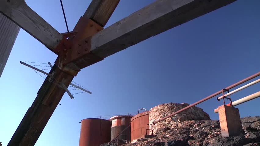 Junction Mine head at Broken Hill. Storage tanks against sky.