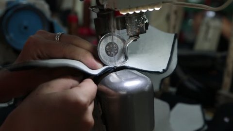 slow motion of sewing machine that stitching on shoe component part