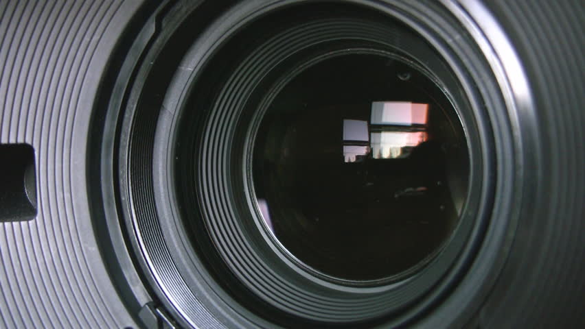 Camera zoom. Closeup shot of professional video camera, with its lens zooming in and out. Canon XH-A1s shot with a Canon HV30. 