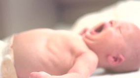 Newborn baby waking up and opening eyes. Close-up. Sleeping Infant. Full HD 1080 video footage. Slow motion Video Footage 240 fps