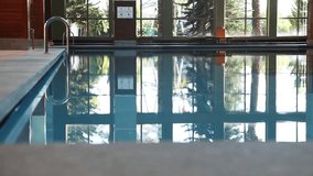 Woman swimming in pool indoor
