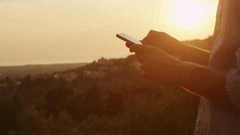 Young Man Using Phone Outdoors at Sunset Time. Shot on RED Digital Cinema Camera in 4K, so you can easily crop, rotate and zoom.
ProResHQ - Great for editing, color correction and grading.
