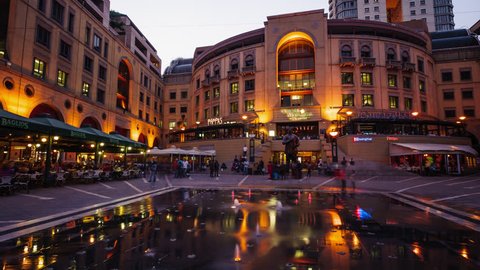 Sandton, Johannesburg, Gauteng, South Africa - 22/09/2012  Nightfall at the Nelson Mandela Square in Sandton, Johannesburg overlooking statue of Nelson Mandela next to the restaurants and fountain.