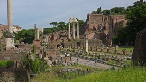 ROME, ITALY - MAY 18, 2014: Multiple tourists visiting Palatine hill with ruins of Roman Forum and other antiquities.