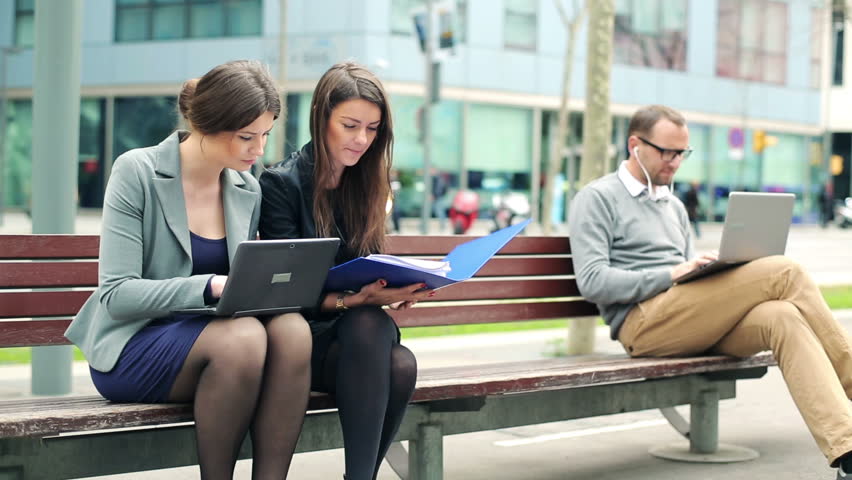 Business people working with laptop and documents in the city
