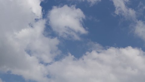 Clouds form and dissolve against a blue sky.  Timelapse recording.  Ultra high definition, 4K.