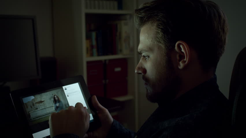 Young man looking his girlffiend photo on facebook on tablet, 4k