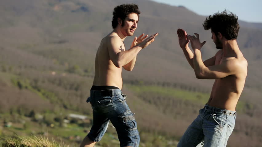 two athletes try martial arts moves: outdoor, mountain, fighting, training