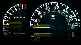Speedometer and Tachometer as vehicle accelerates reflecting off black glass.