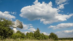 The parabolic antenna on a background of the blue sky. RAW video record.