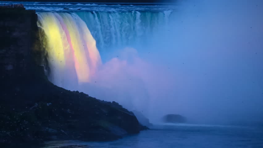 Niagara Falls - Birds Fly in Front of Illuminated Horseshoe Falls a.k.a. Canadian Falls as Seen from the Canadian Side in the Evening