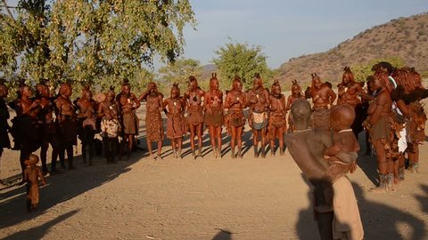 NAMIBIA, AFRICA - JUNE 24: Himba tribe, June 24, 2013. The Himba are indigenous ancient tribe living in Namibia, in one of the most extreme environments on earth. Dancing Himba women,  with sound
