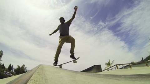 Slow Motion Extreme Skateboarder Grinds Down Rail 
