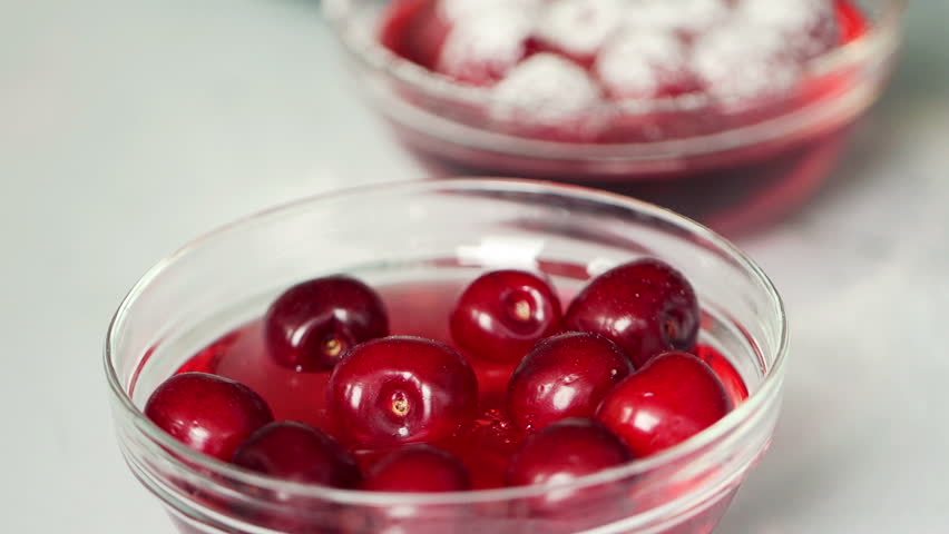 Whipped cream on jelly with cherries, super slow motion, shot at 240fps
