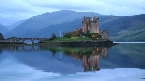 DORNIE, HIGHLAND/SCOTLAND - JUNE 09, 2014: Eilean Donan Castle on Loch Duich at twilight. The castle was founded in the 13th Century during the reign of Alexander II.