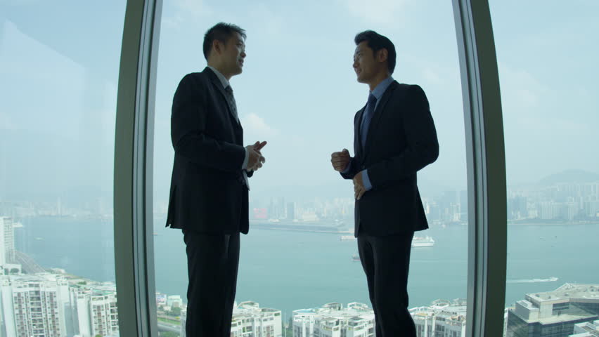 Successful young male Asian Chinese share brokers meeting shaking hands window modern skyscraper building overlooking panoramic view city shot on RED EPIC | Shutterstock HD Video #6723934