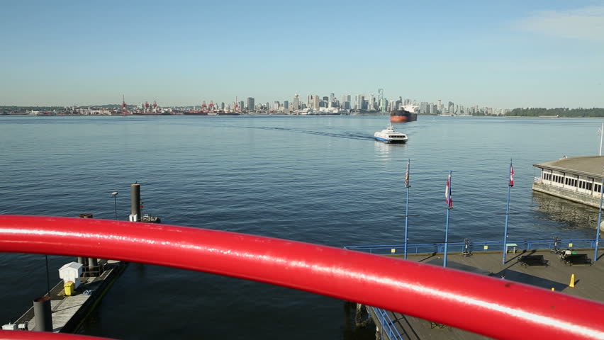 Burrard Inlet High Angle View, North Vancouver. A dolly shot of the Seabus, a commuter ferry, returning to the North Vancouver terminal after crossing Burrard Inlet. Vancouver, British Columbia.