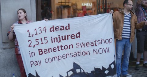 Demo outside Benetton in London - compensation for sweatshop disaster in Bangladesh, where garment factory collapsed killing 1,134 people and injuring over 2,500. June 18 2014, Oxford St, London.
